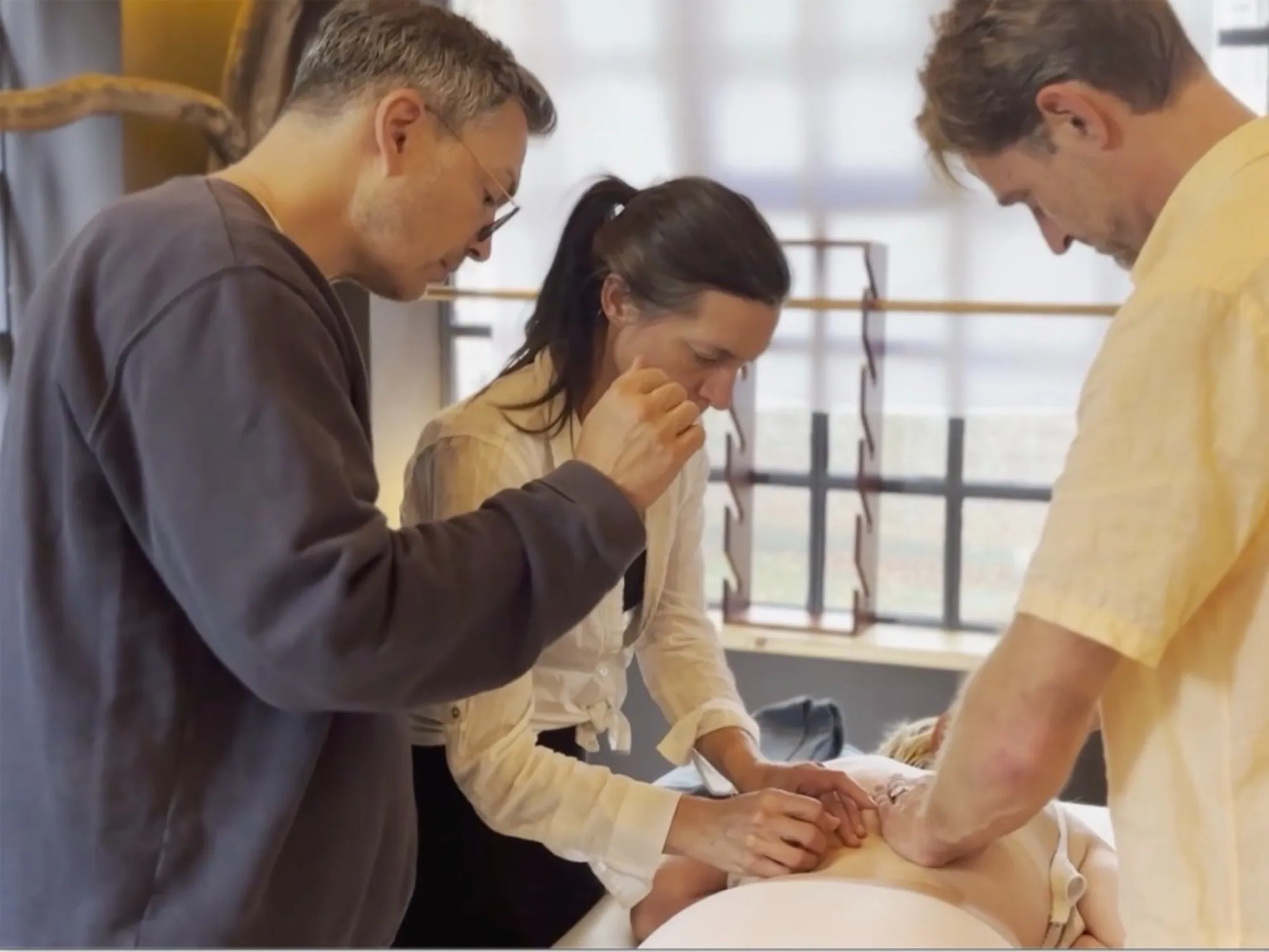 Darren Rose teaching acupuncture with colleagues in clinic